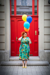 Full length of a girl holding balloons