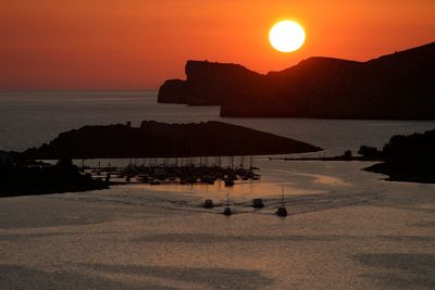 Scenic view of sea against orange sky