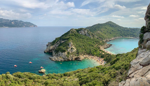 High angle view of sea and mountains against sky