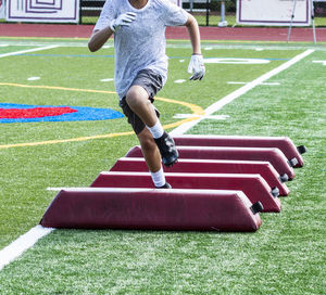 Low section of boy playing on grassland