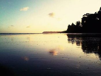 Scenic view of calm lake at sunset