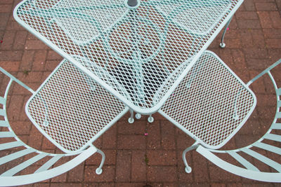 High angle view of empty chairs on tiled floor