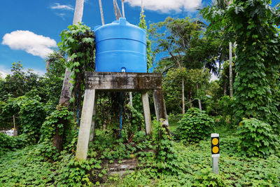 Low angle view of water tower on land against sky