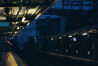 Train on railroad station platform at night