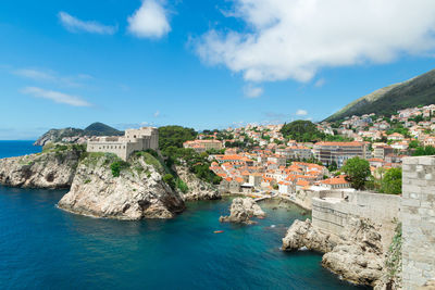 Fort lovrijenac by adriatic sea against cloudy sky