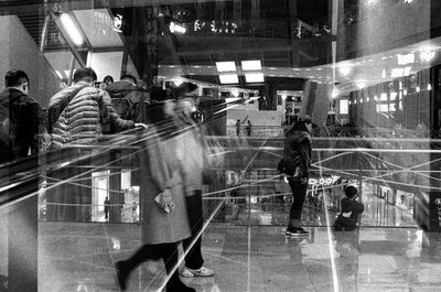 People walking on illuminated street in city