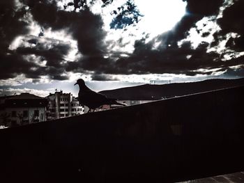 Buildings against cloudy sky