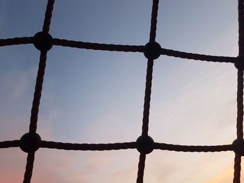 Low angle view of fence against sky