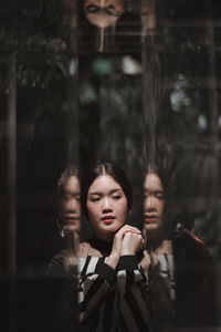 Portrait of young couple standing in glass