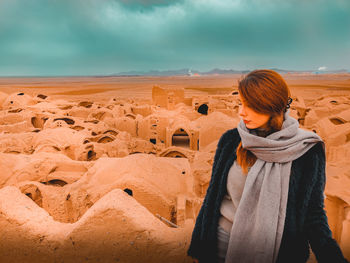 Full length of woman standing on land against sky