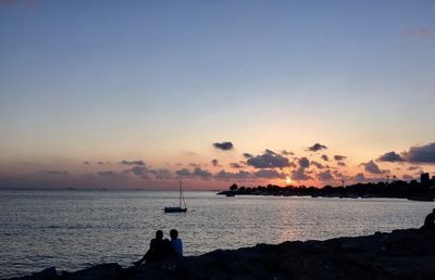 Scenic view of sea against sky at sunset