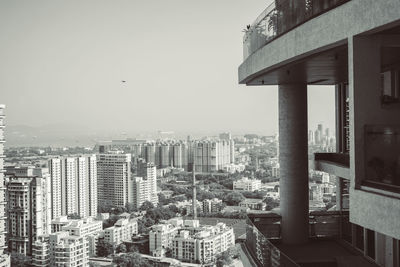 Buildings in city against clear sky