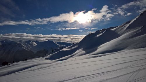 Scenic view of snowcapped mountains against sky