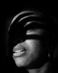 Close-up of woman with shadow in darkroom