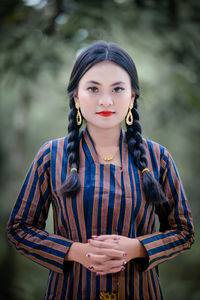 Portrait of young woman standing outdoors