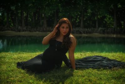 Portrait of woman sitting on grass