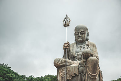 Low angle view of statue against sky