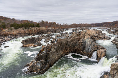 Panoramic view of rocks on land against sky