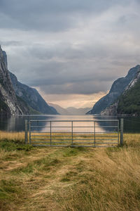 Scenic view of mountains and fjord against sky