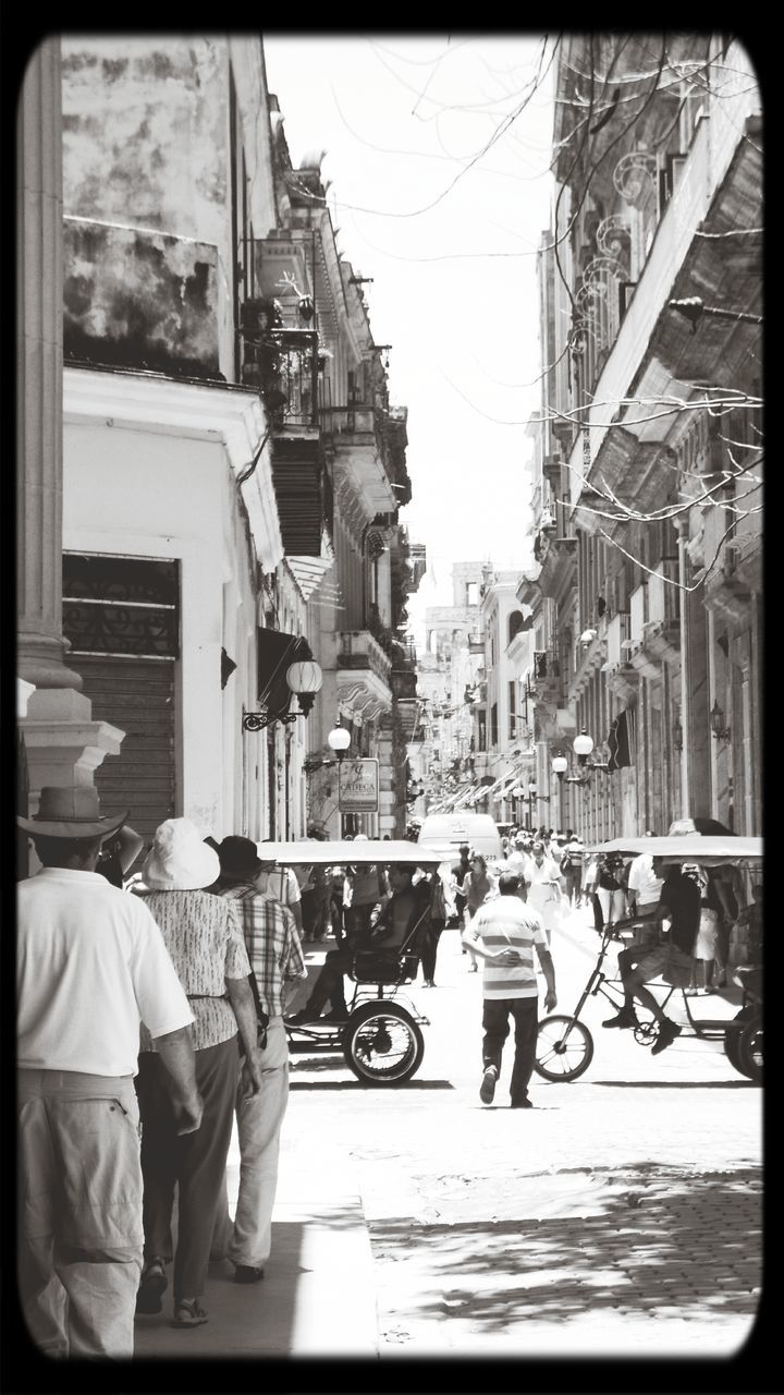 transfer print, building exterior, architecture, built structure, men, lifestyles, person, city, auto post production filter, street, transportation, large group of people, city life, mode of transport, land vehicle, leisure activity, walking, car, day