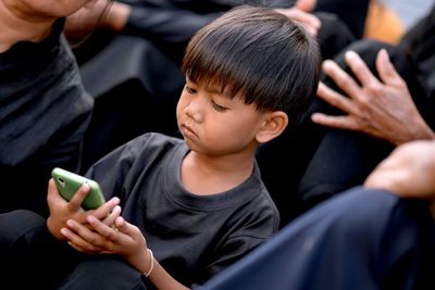 Close-up of boy using mobile phone