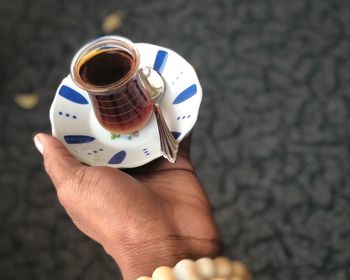 High angle view of person holding tea cup