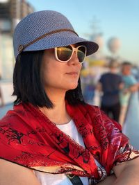 Close-up of woman wearing sunglasses and hat outdoors