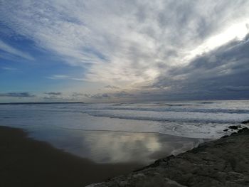 Scenic view of beach against sky during sunset