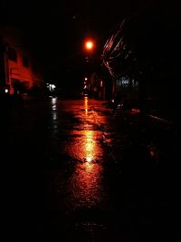 Illuminated street during rainy season at night