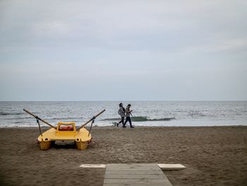 People on beach against sky