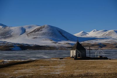 Scenic view of snowcapped mountains against clear blue sky