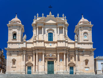 Low angle view of historical building against clear blue sky