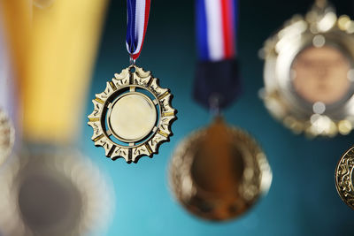Close-up of gold medals against blackboard
