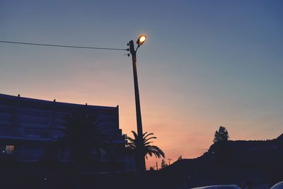 Low angle view of street light against sky at sunset