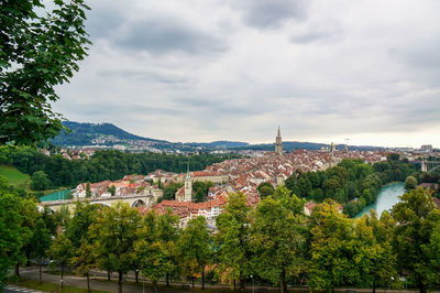 High angle view of townscape by sea against sky