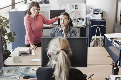 Business people discussing at desk in office