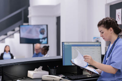 Side view of doctor working at office