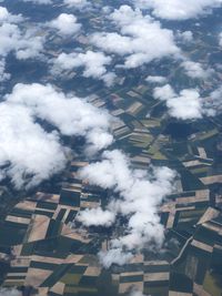 Low angle view of smoke emitting from clouds against sky