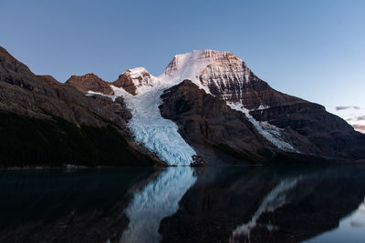 Scenic view of snowcapped mountains against clear blue sky