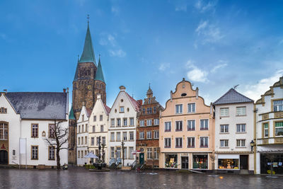 Market square with beautiful hisyorical houses and church in warendorf, germany