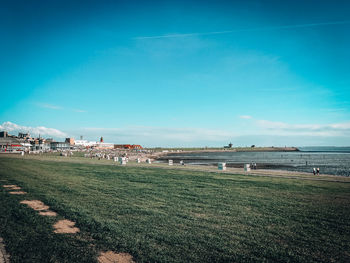 Scenic view of field against blue sky