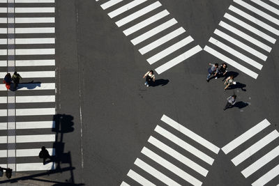 High angle view of people walking on road