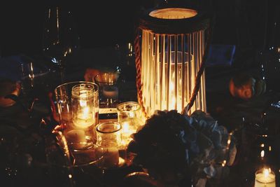 Close-up of lit tea light candles on table