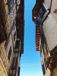 Low angle view of buildings against clear blue sky