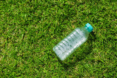 High angle view of bottle on field