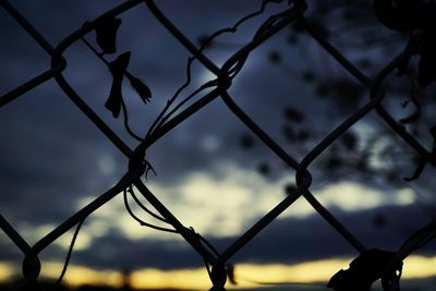 Close-up of chainlink fence against sky