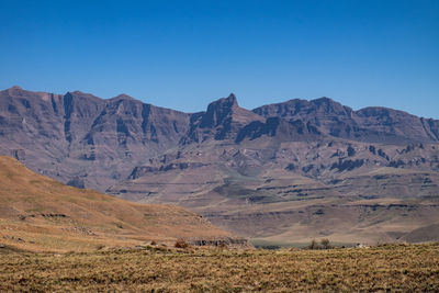 Scenic view of mountains against clear blue sky