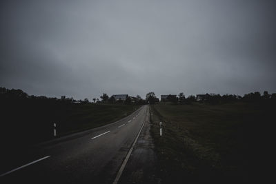 Road passing through landscape against sky