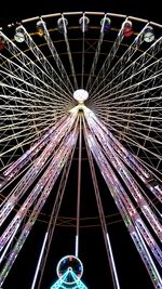 Low angle view of illuminated ferris wheel at night