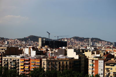 Buildings in city against sky